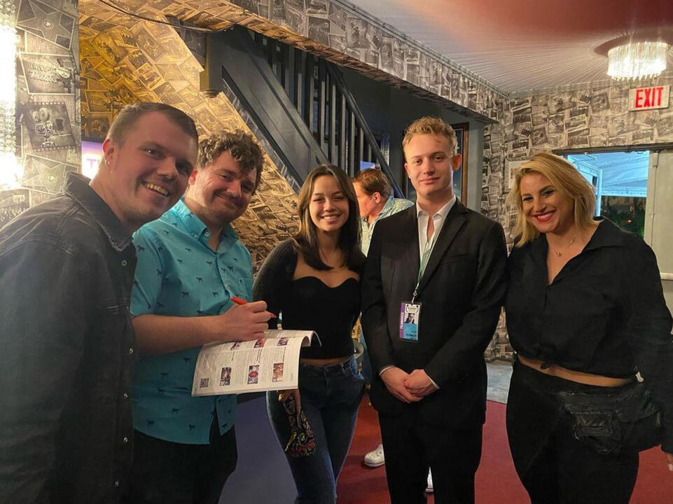 John A. Bryant, Will Brady, My Linh Tinnirella, and JoJo Scanlon signing a program after the screening at FLIFF